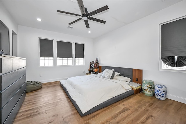 bedroom with hardwood / wood-style flooring and ceiling fan