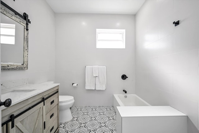 bathroom featuring vanity, plenty of natural light, tile walls, and toilet