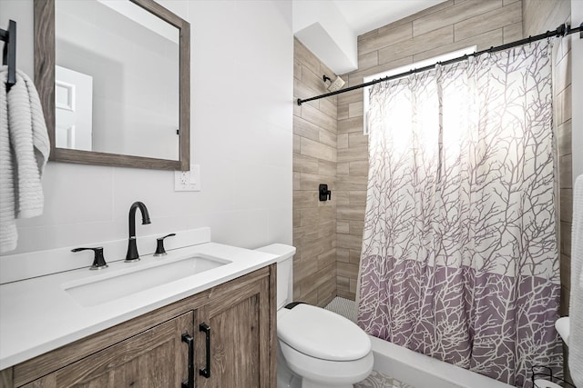 bathroom featuring toilet, tile walls, vanity, a shower with shower curtain, and backsplash