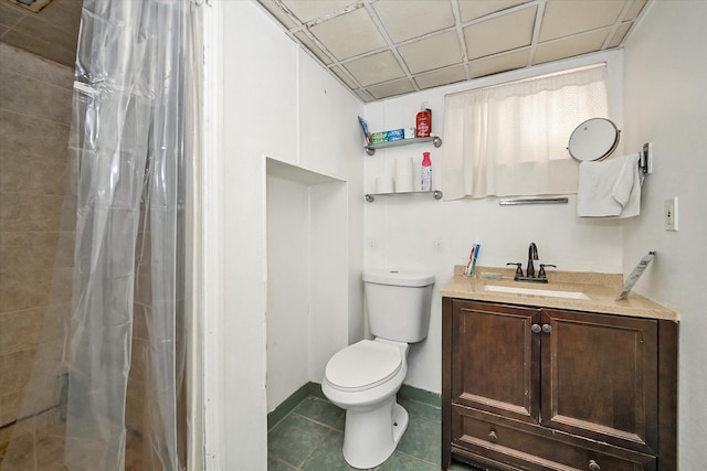 bathroom featuring tile patterned floors, toilet, a shower with curtain, a paneled ceiling, and vanity