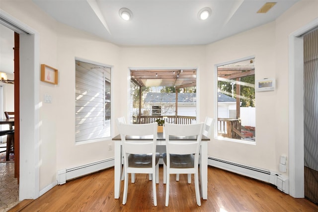 dining room featuring a baseboard radiator and wood-type flooring