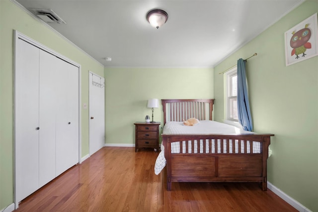 bedroom featuring crown molding and hardwood / wood-style floors