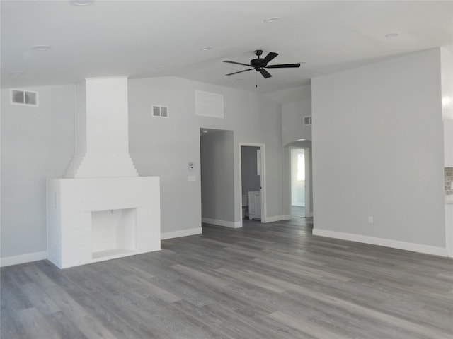 unfurnished living room with hardwood / wood-style flooring, ceiling fan, and lofted ceiling