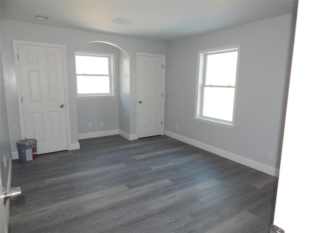 empty room with dark hardwood / wood-style flooring