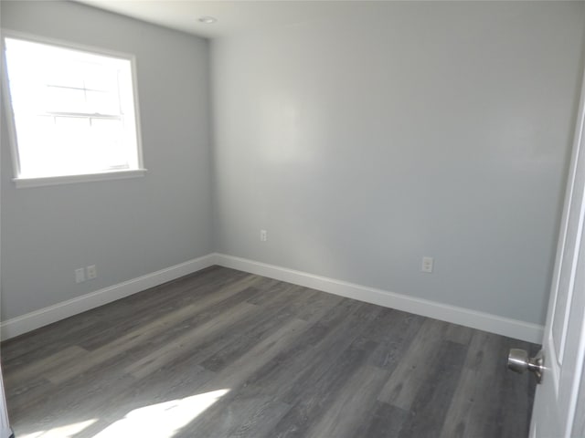 unfurnished room featuring dark wood-type flooring