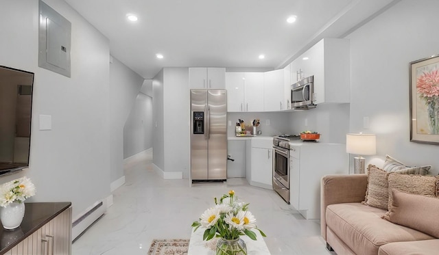 kitchen featuring electric panel, a baseboard radiator, appliances with stainless steel finishes, marble finish floor, and white cabinetry