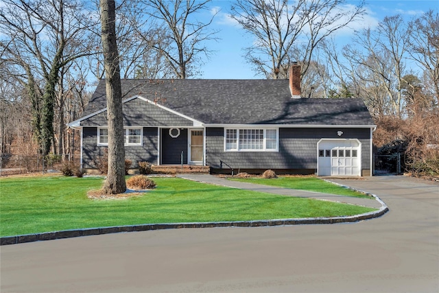 ranch-style home featuring a garage and a front lawn