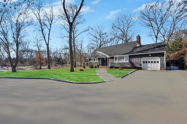 ranch-style house with a garage and a front lawn