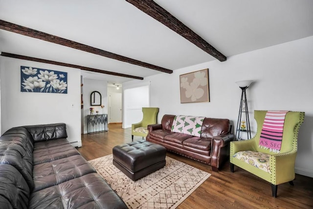 living room featuring beamed ceiling, dark hardwood / wood-style flooring, and a baseboard heating unit