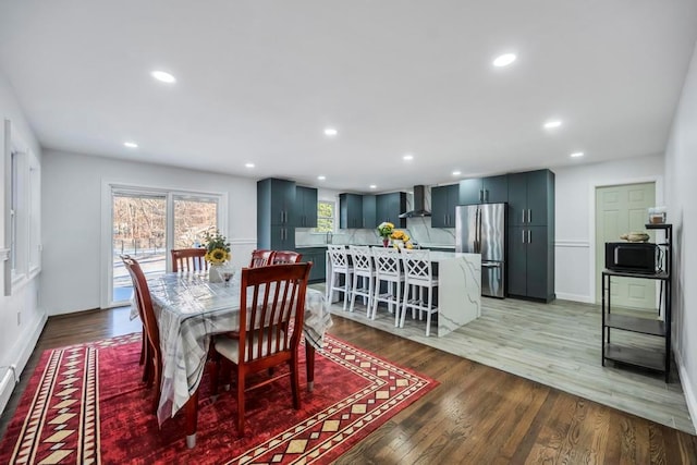 dining area with hardwood / wood-style floors