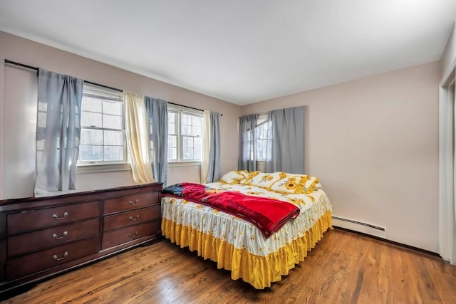 bedroom featuring a baseboard radiator and wood-type flooring