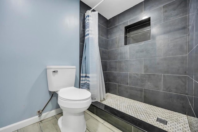 bathroom featuring curtained shower and toilet