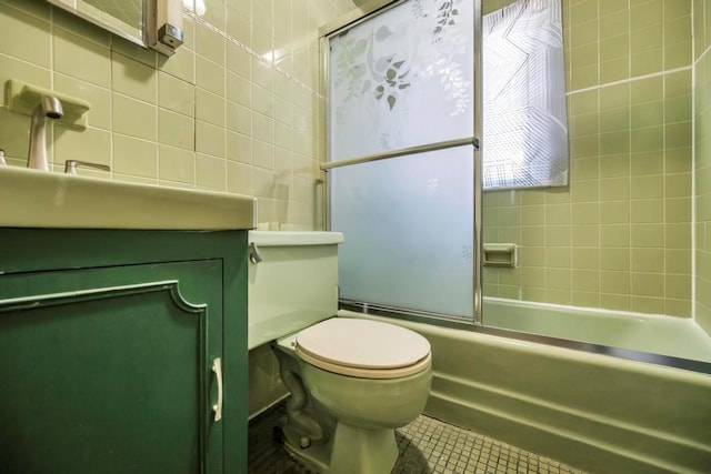 full bathroom featuring enclosed tub / shower combo, tile walls, tile patterned flooring, vanity, and toilet