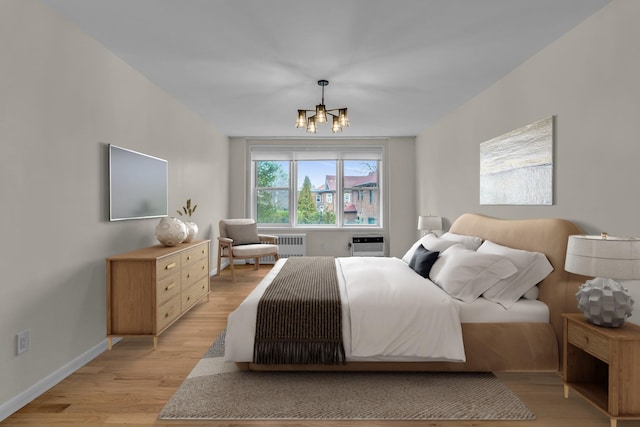 601 Kappock St Unit 3P, Bronx, NY 10463 - bedroom featuring radiator heating unit, an inviting chandelier, a wall mounted AC, and light wood-type flooring