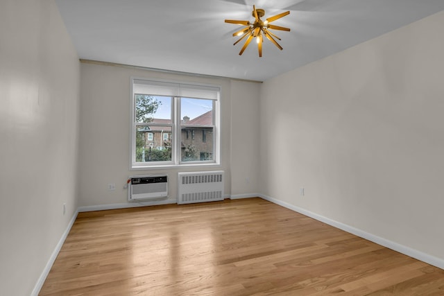 601 Kappock St Unit 3P, Bronx, NY 10463 - empty room featuring a chandelier, a wall mounted AC, radiator, and light hardwood / wood-style floors