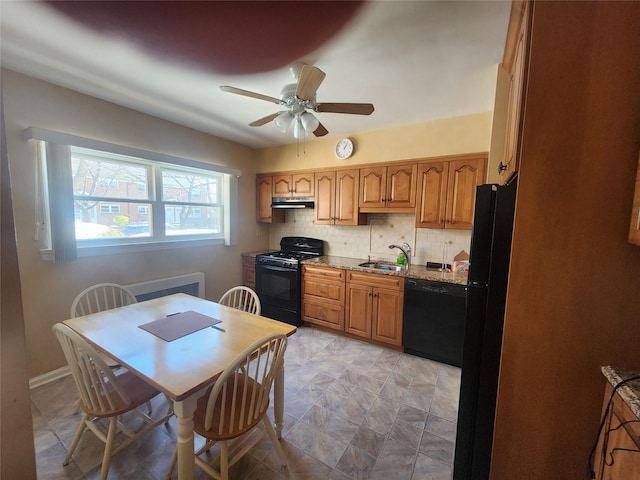 kitchen with sink, ceiling fan, tasteful backsplash, light stone countertops, and black appliances