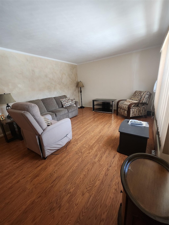 living room featuring hardwood / wood-style flooring and crown molding