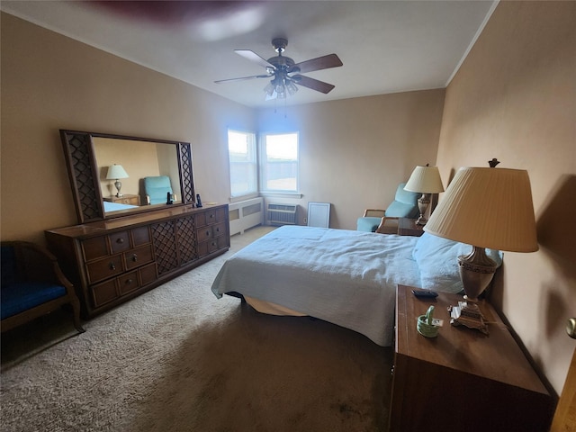 carpeted bedroom with ceiling fan and radiator