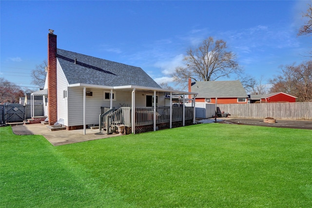 back of house featuring a patio and a lawn