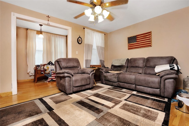 living room with ceiling fan and light hardwood / wood-style floors