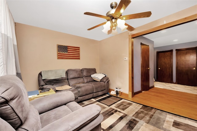 living room featuring hardwood / wood-style flooring, vaulted ceiling, and ceiling fan