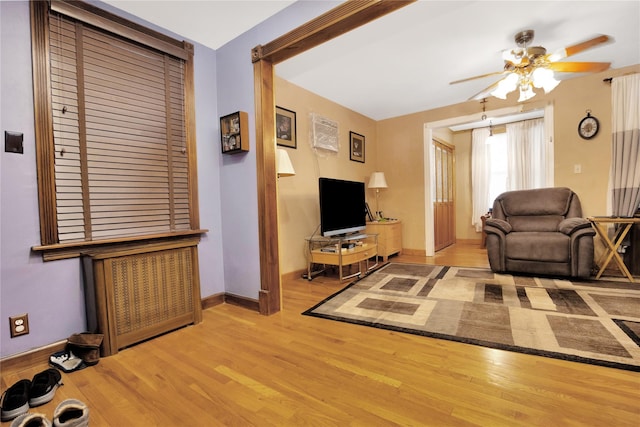 living room with ceiling fan and light hardwood / wood-style floors