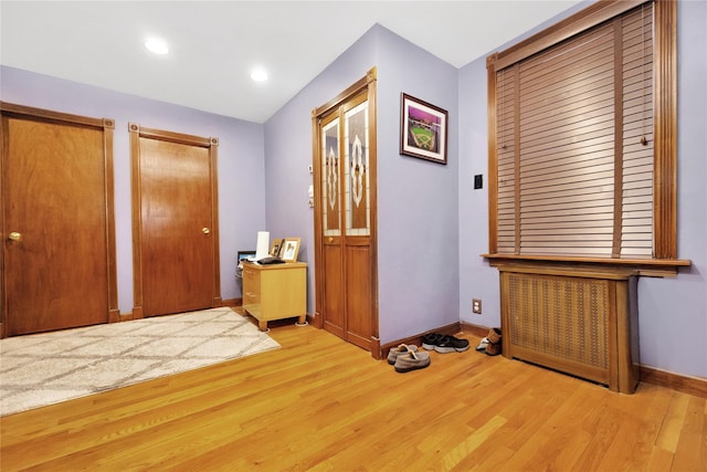 corridor with light hardwood / wood-style flooring