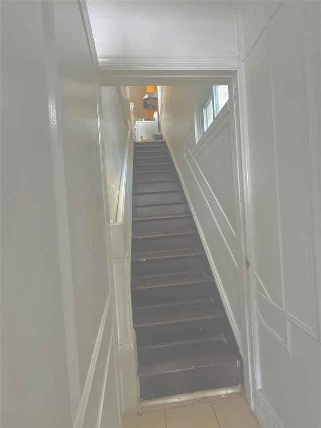 stairway featuring tile patterned flooring