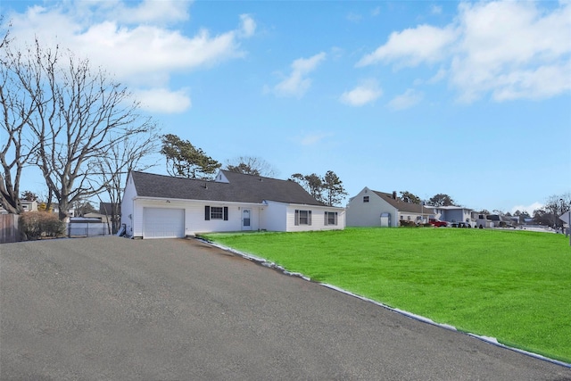 view of front of property featuring a garage and a front yard