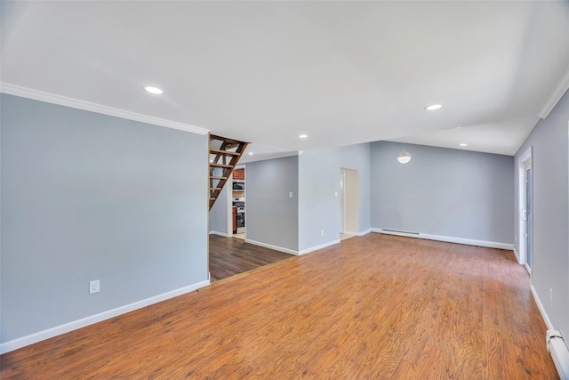 unfurnished living room with crown molding, hardwood / wood-style floors, and baseboard heating