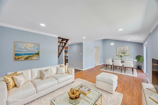 living room featuring lofted ceiling, hardwood / wood-style floors, and crown molding