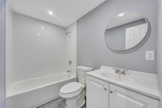 full bathroom featuring tile patterned flooring, vanity, toilet, and tiled shower / bath