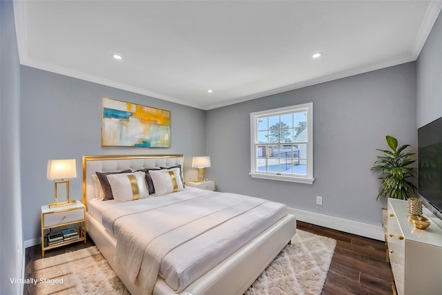 bedroom with dark wood-type flooring, ornamental molding, and baseboard heating