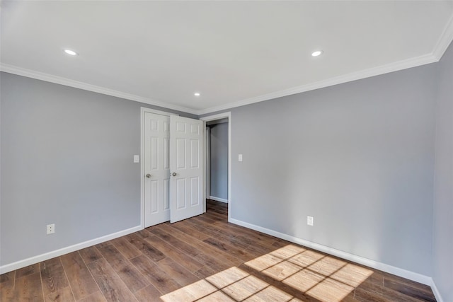 unfurnished room featuring crown molding and wood-type flooring