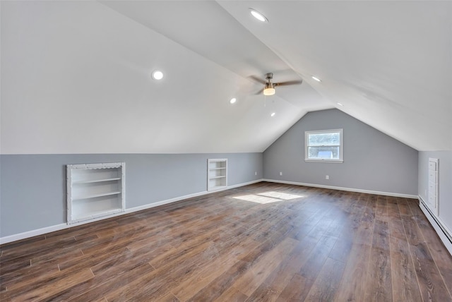 bonus room featuring dark wood-type flooring, a baseboard radiator, lofted ceiling, and built in features