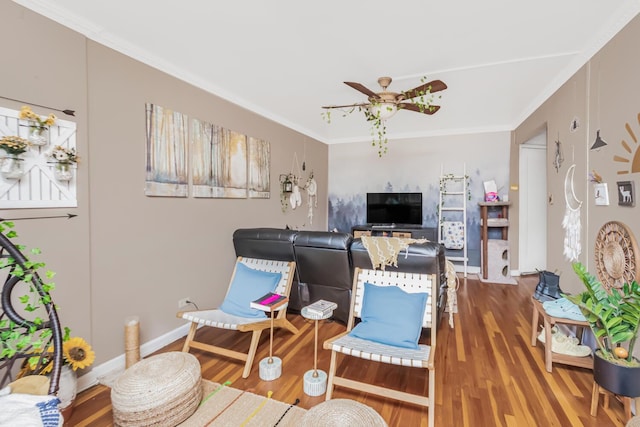 living room with hardwood / wood-style flooring, crown molding, and ceiling fan