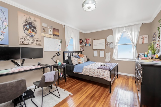 bedroom featuring hardwood / wood-style flooring and ornamental molding