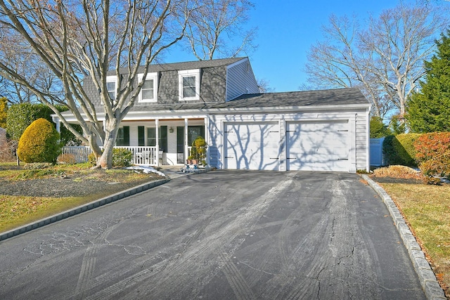 view of front facade with a garage and covered porch