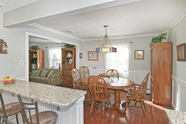 dining room featuring dark wood-type flooring and ornamental molding