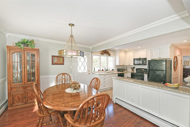 dining room featuring baseboard heating, ornamental molding, and dark hardwood / wood-style floors