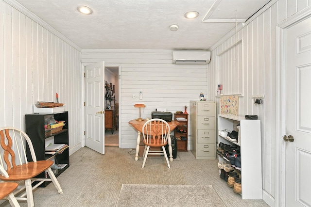 home office with light carpet, crown molding, a wall unit AC, and a textured ceiling