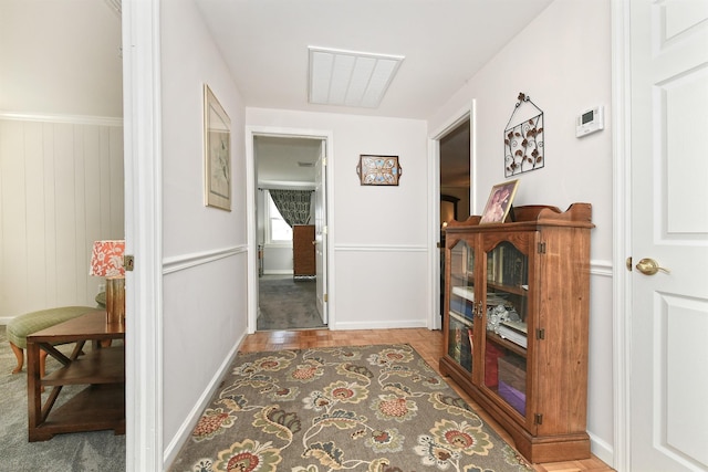 hall featuring wooden walls