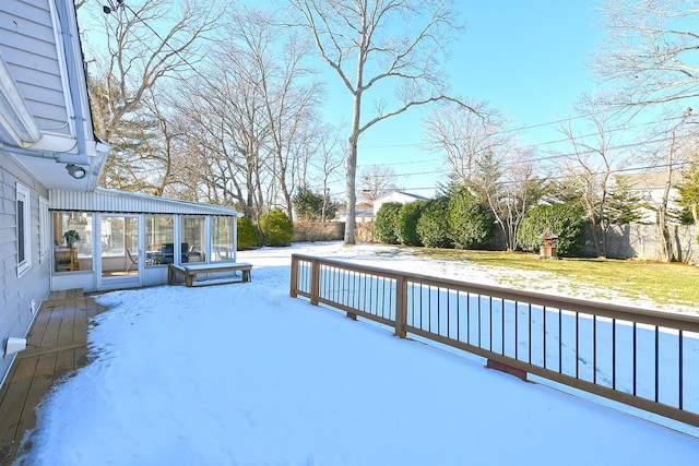 wooden deck with a yard and a sunroom