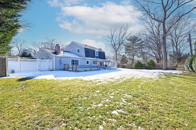 rear view of house featuring a yard and a deck