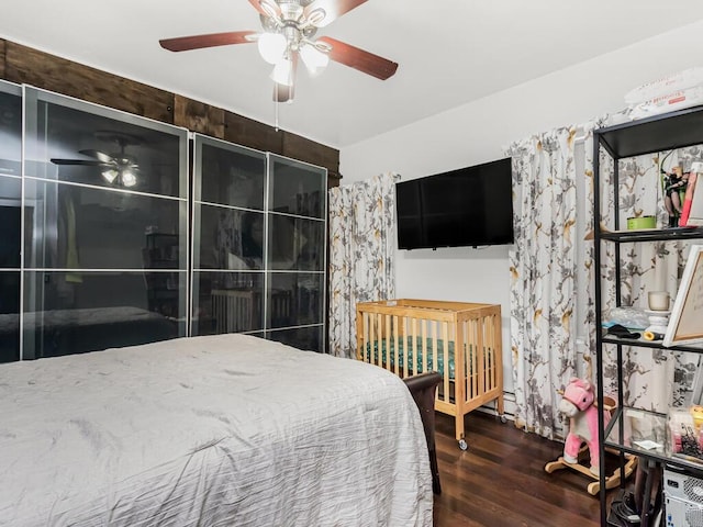 bedroom with dark wood-type flooring and ceiling fan