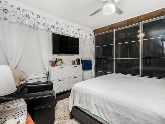 bedroom with ceiling fan and wood-type flooring