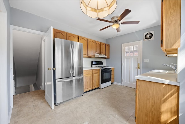 kitchen featuring sink, range with gas cooktop, stainless steel fridge, and ceiling fan