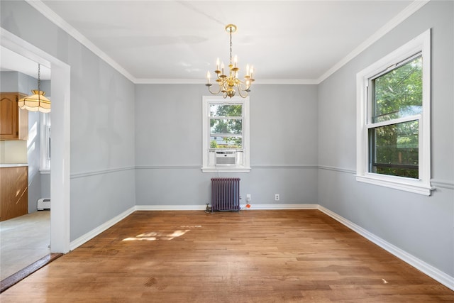 unfurnished dining area featuring a wealth of natural light, radiator heating unit, light hardwood / wood-style floors, and a chandelier