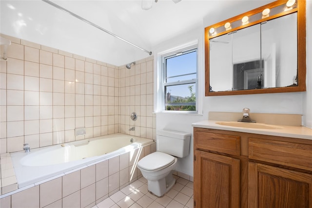 full bathroom featuring tiled shower / bath combo, vanity, tile patterned floors, and toilet