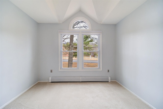 carpeted empty room featuring lofted ceiling and baseboard heating